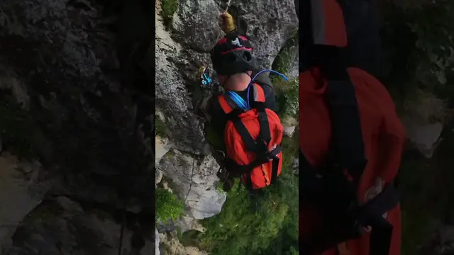 Via ferrata climbing Short with a climber on an exposed route